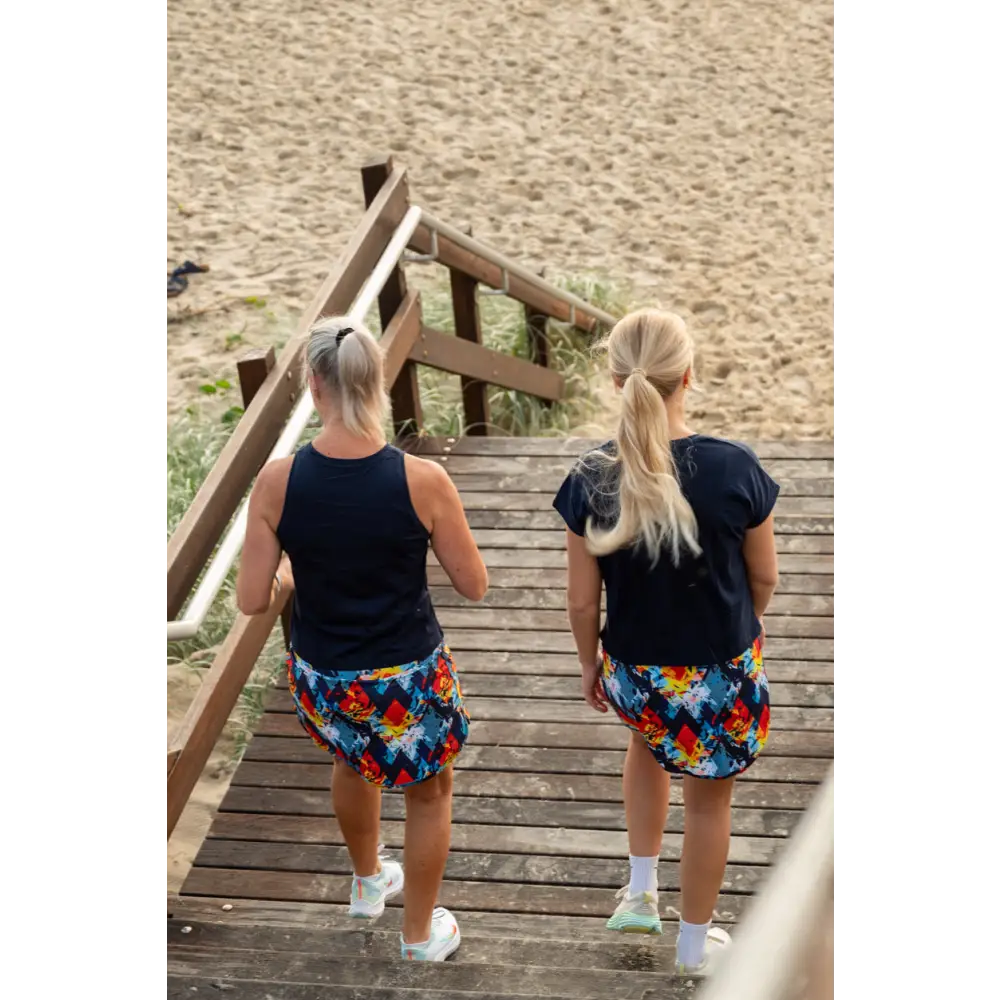 Aztec Skort with Pockets - Abstract print skort in vibrant red, yellow, and blue diamond patterns. The comfortable design includes practical pockets on the integrated undershorts.