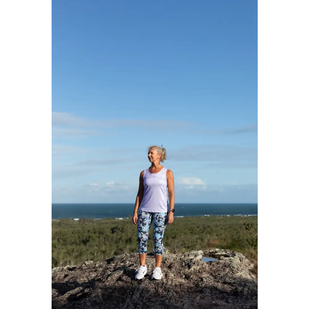 Lilac Full Back Sports Singlet Super comfortable light weight Sports Singlets Specially designed for those that prefer a looser fit The generous length sits nicely over hips and bottom Moisture wicking properties will keep you cool and dry Fade resistant Polyester/Spandex Features a Full Back Design The hemline also features a slight scalloped finish.