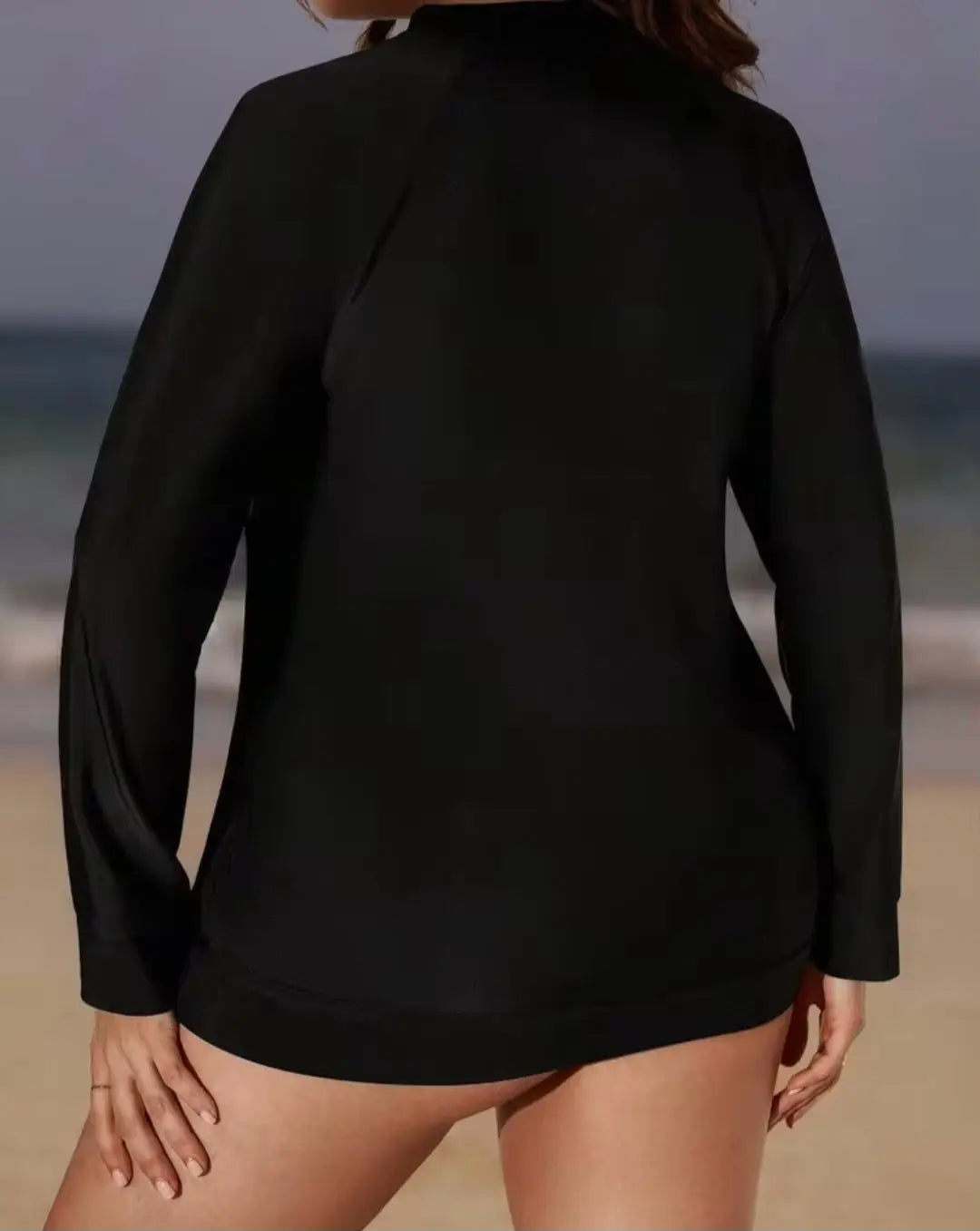 Black full zip rashie top with high neckline and smooth stretchy fabric designed for activewear use