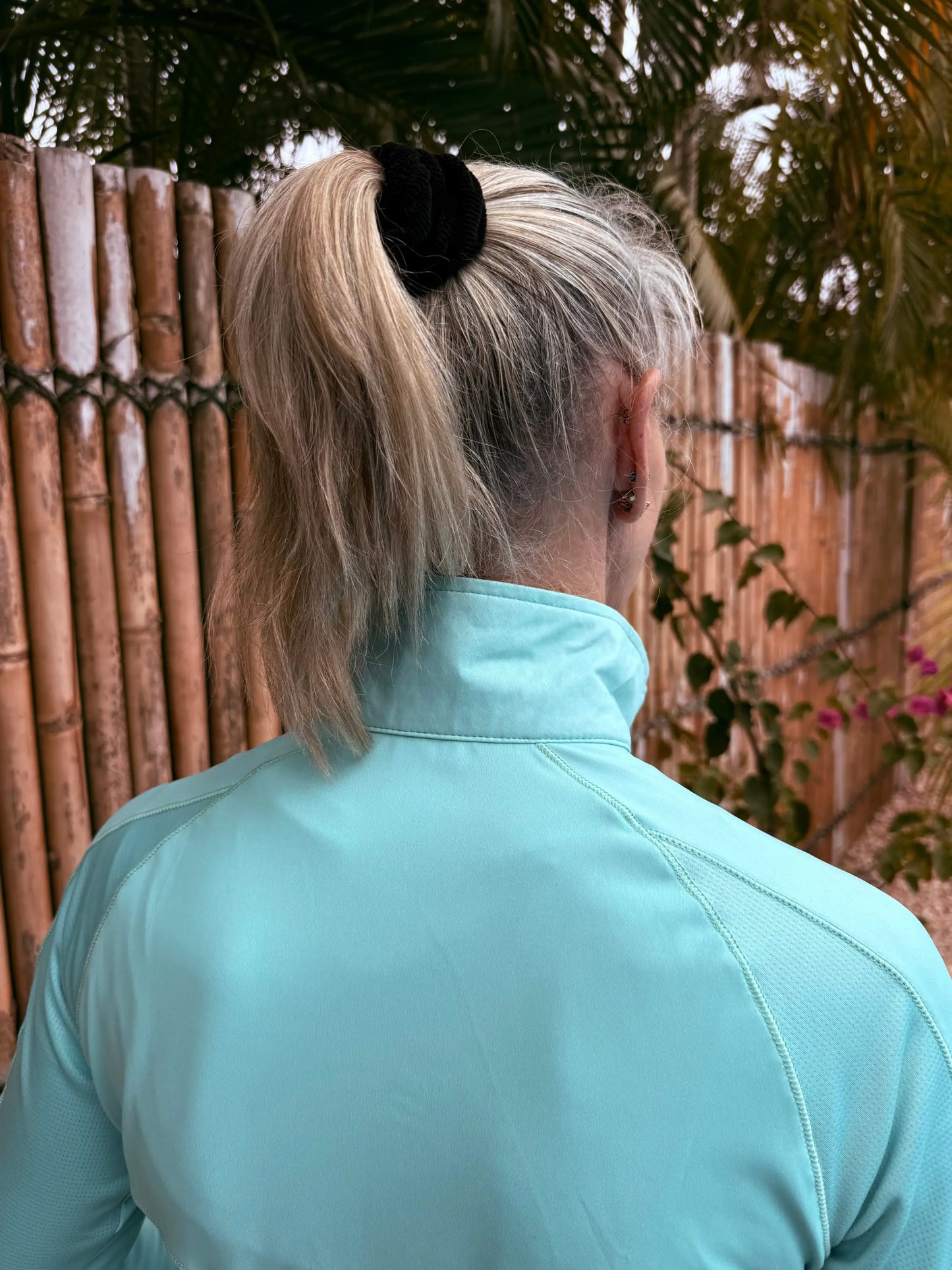 Black velvet hair tie securing a blonde ponytail shown with emma sports jacket in xs to 3xl collection