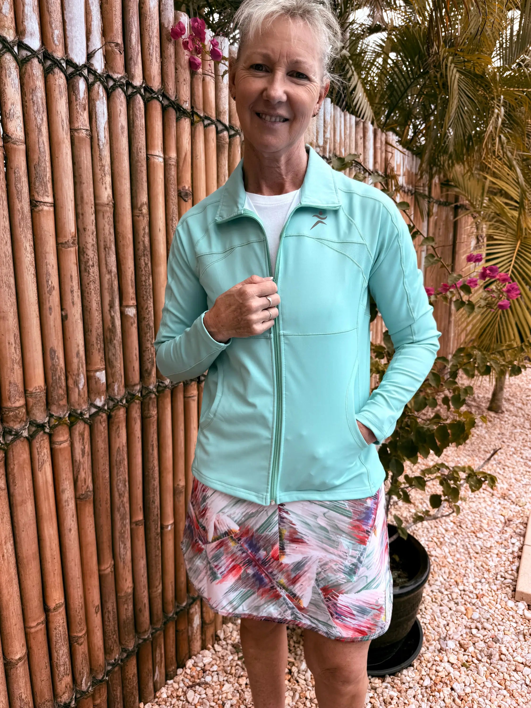 Light blue emma sports jacket with zip-up front and subtle chest logo available in xs to 3xl sizes