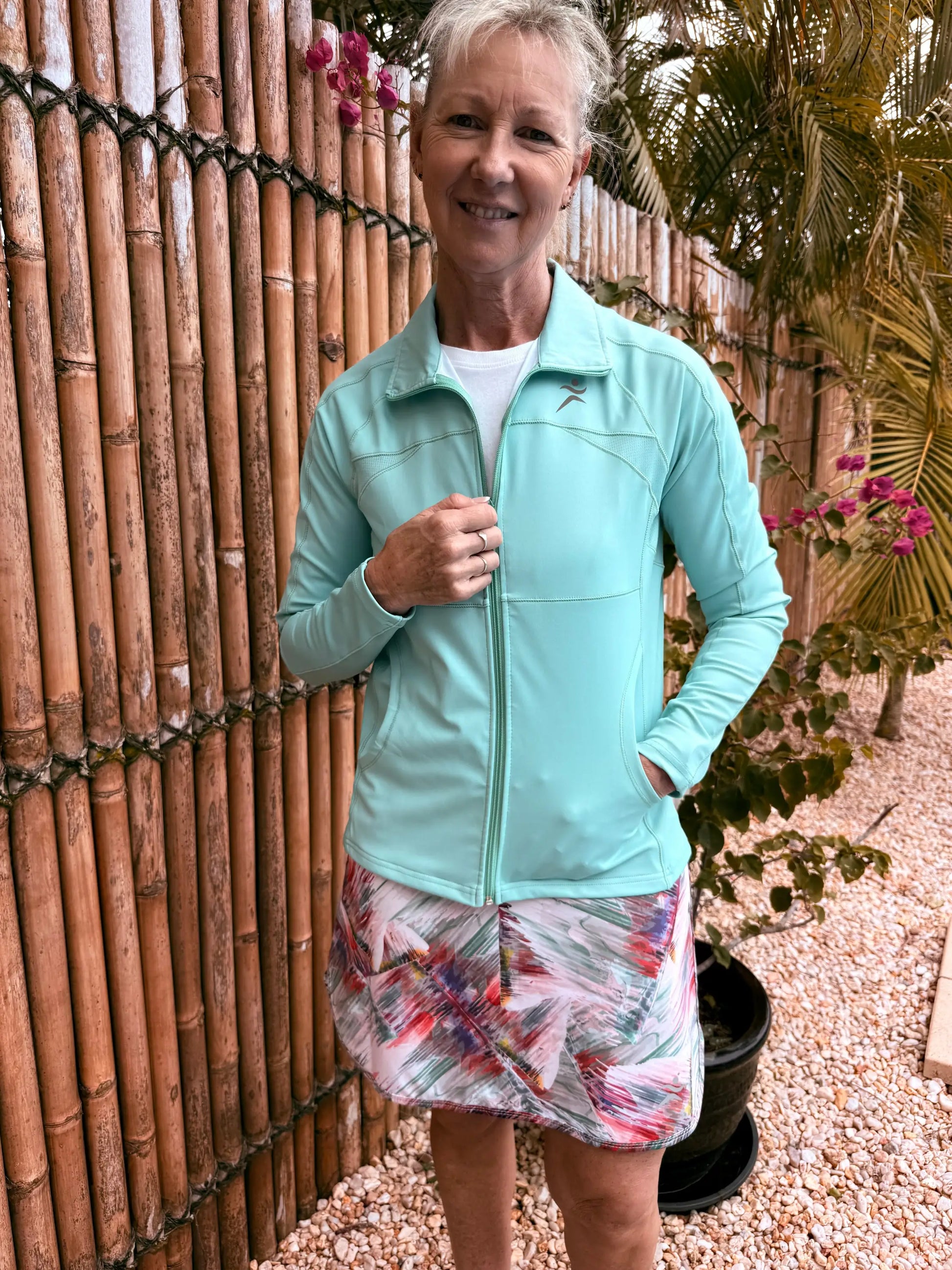 Light blue emma sports jacket with zip-up front and subtle chest logo available in xs to 3xl sizes
