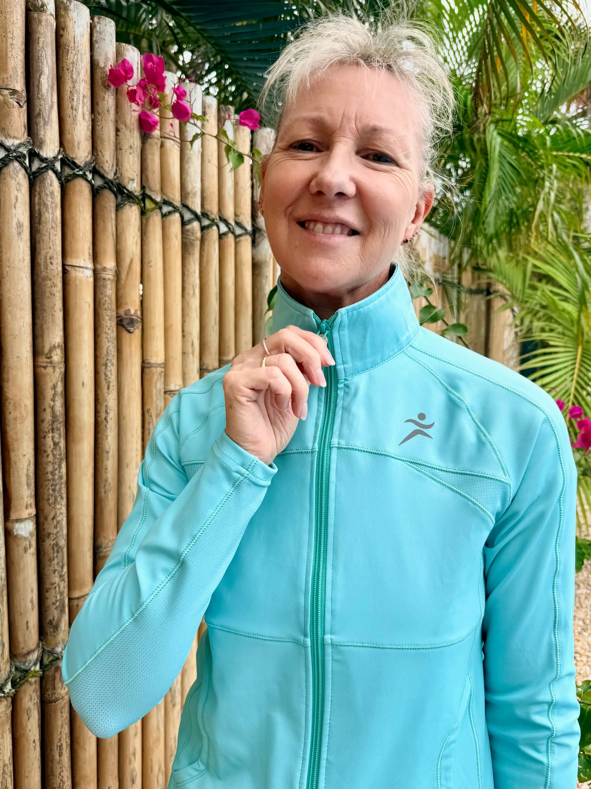 Light blue emma sports jacket with zip-up front, subtle textured pattern, and small logo on left chest in sizes XS to 3XL