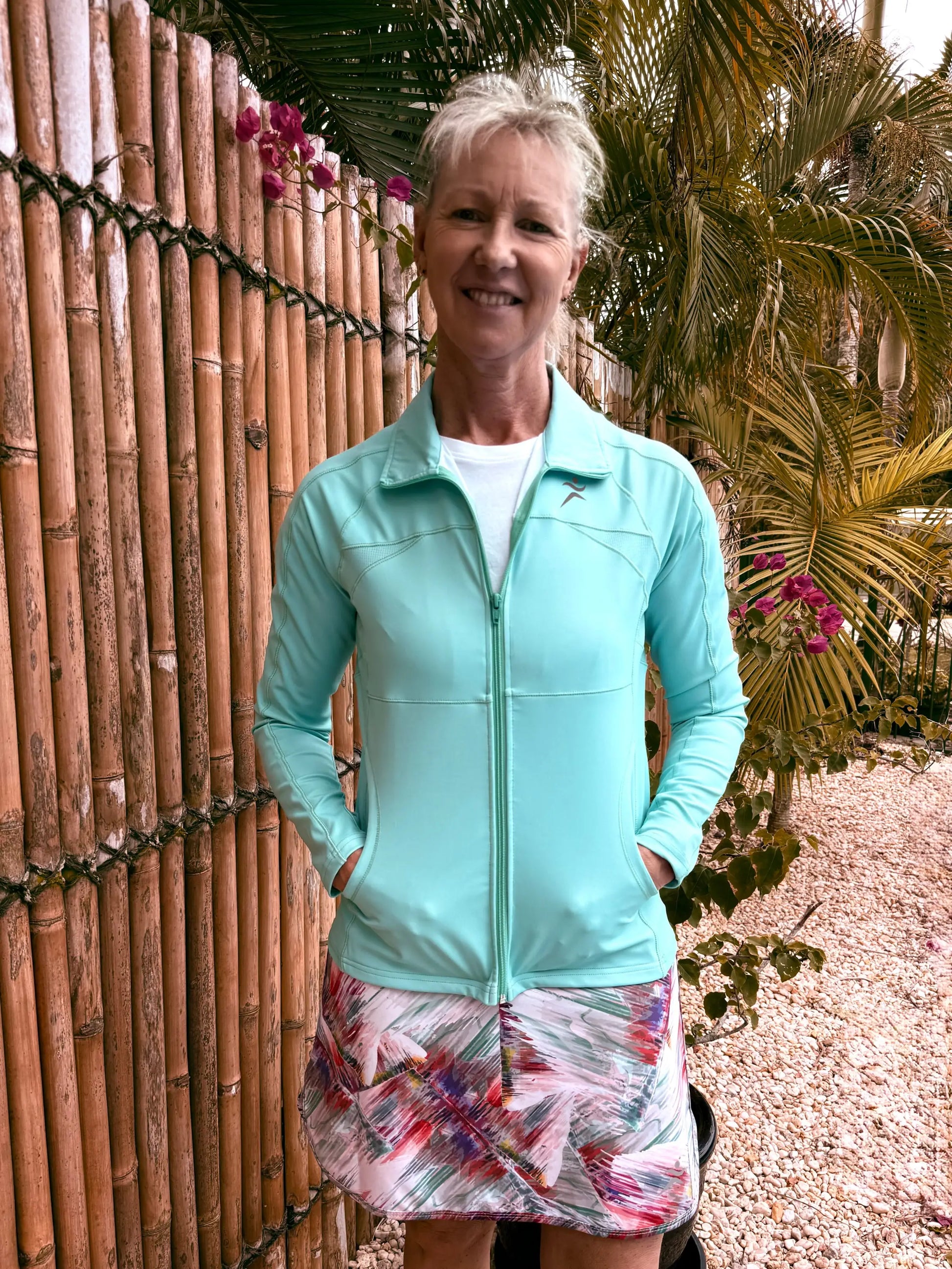 Emma sports jacket in light blue zip-up design with subtle logo on left chest available in XS to 3XL sizes