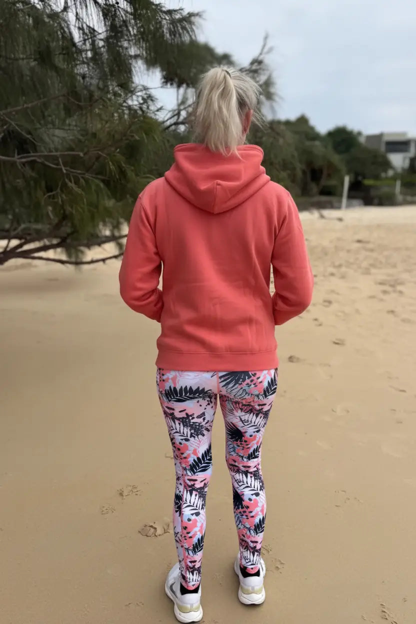 A coral-colored fleecy zip hoodie with a soft casual fit perfect for comfortable everyday wear