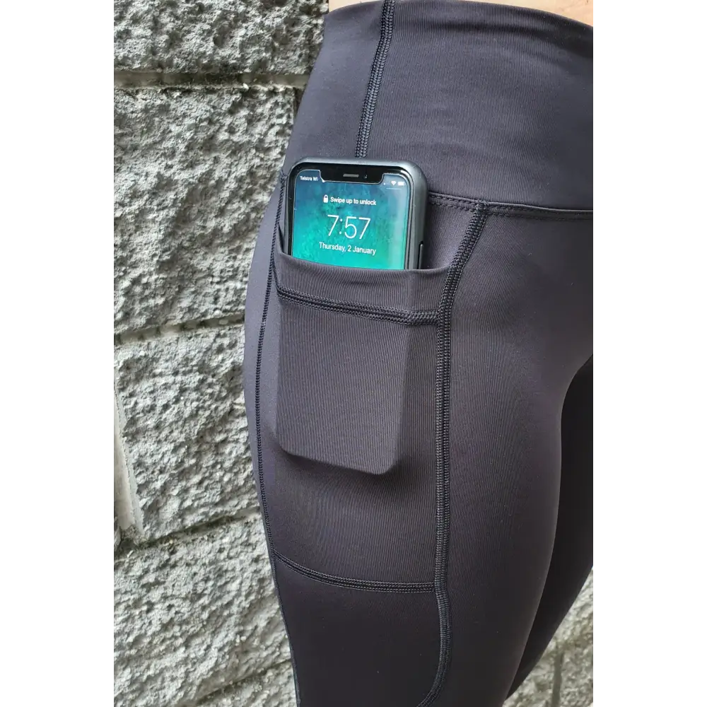 Gmaxx 'ATTACK Black Active 3/4 Leggings - A sleek, 3/4 black high-performance legging designed for all physical activities. It features two large side pockets and a small fob/coin pocket for secure storage.