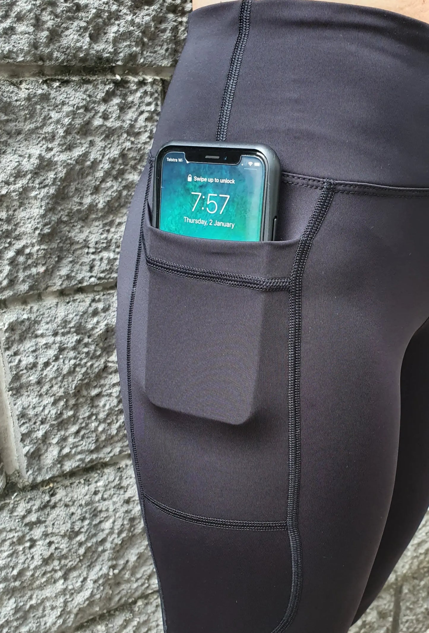 Gmaxx 'ATTACK Black Active 3/4 Leggings - A sleek, 3/4 black high-performance legging designed for all physical activities. It features two large side pockets and a small fob/coin pocket for secure storage.