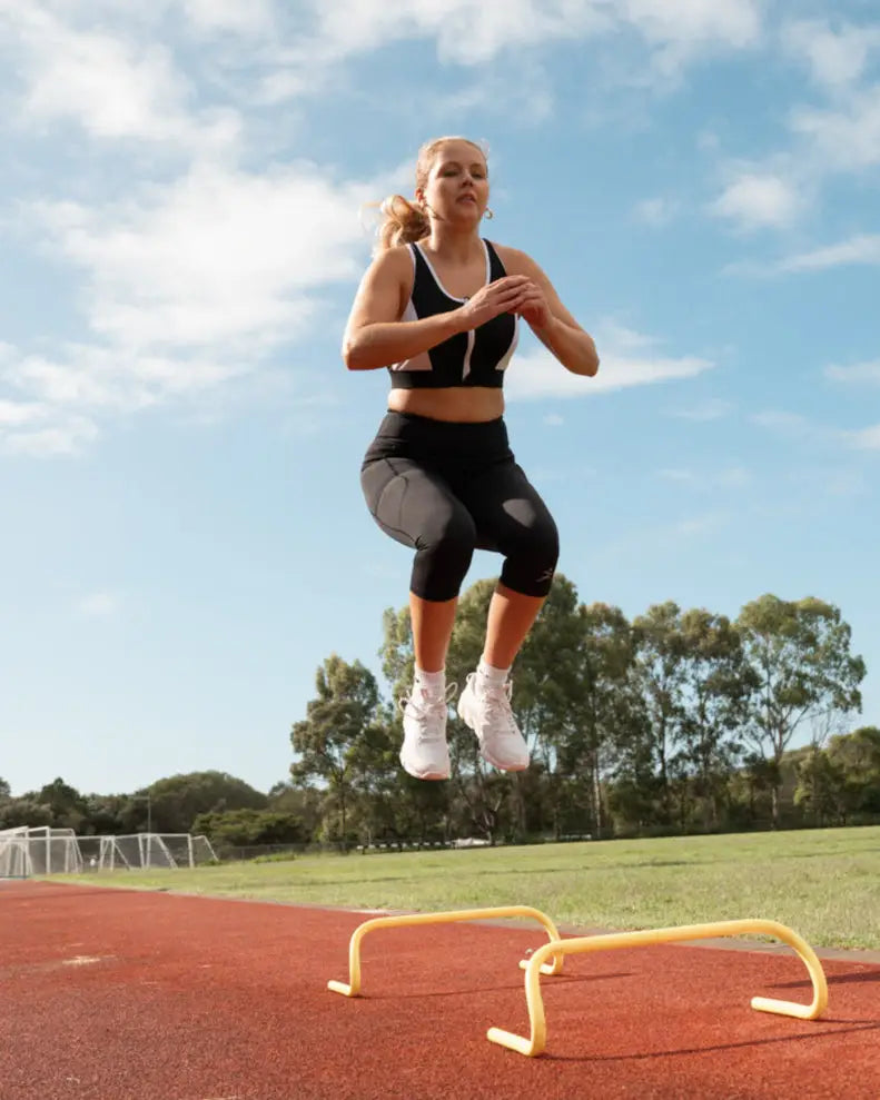 Gmaxx 'ATTACK Black Active 3/4 Leggings - A sleek, 3/4 black high-performance legging designed for all physical activities. It features two large side pockets and a small fob/coin pocket for secure storage.