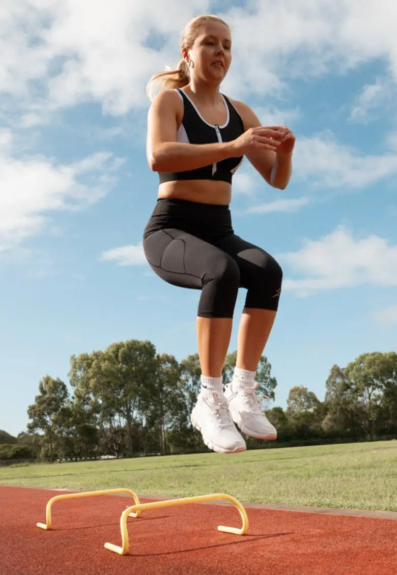 Gmaxx 'ATTACK Black Active 3/4 Leggings - A sleek, 3/4 black high-performance legging designed for all physical activities. It features two large side pockets and a small fob/coin pocket for secure storage.