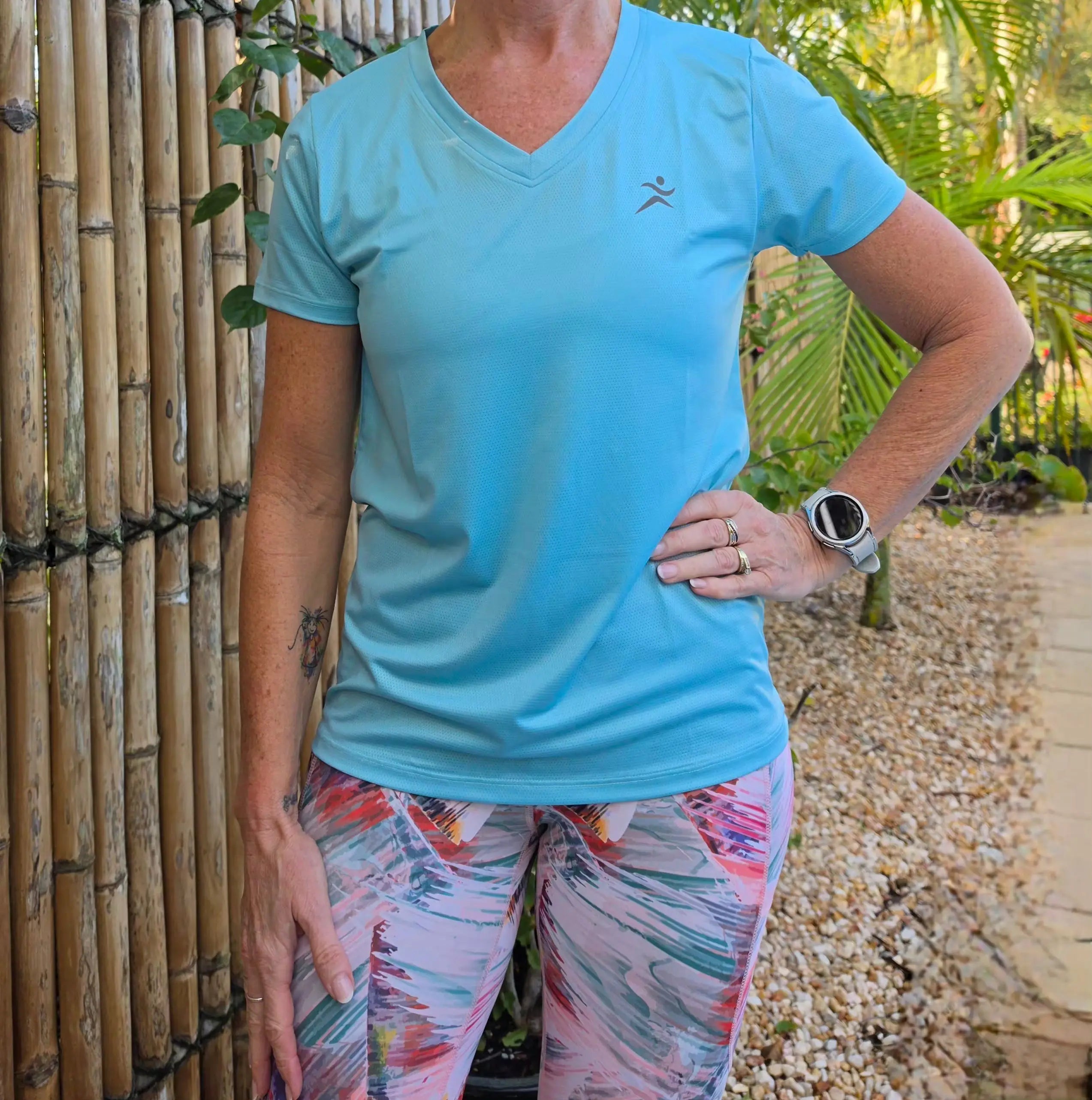 Light blue gmaxx mesh lightweight v-neck activewear top with dark gray running figure logo on left chest in sizes XS to 3XL
