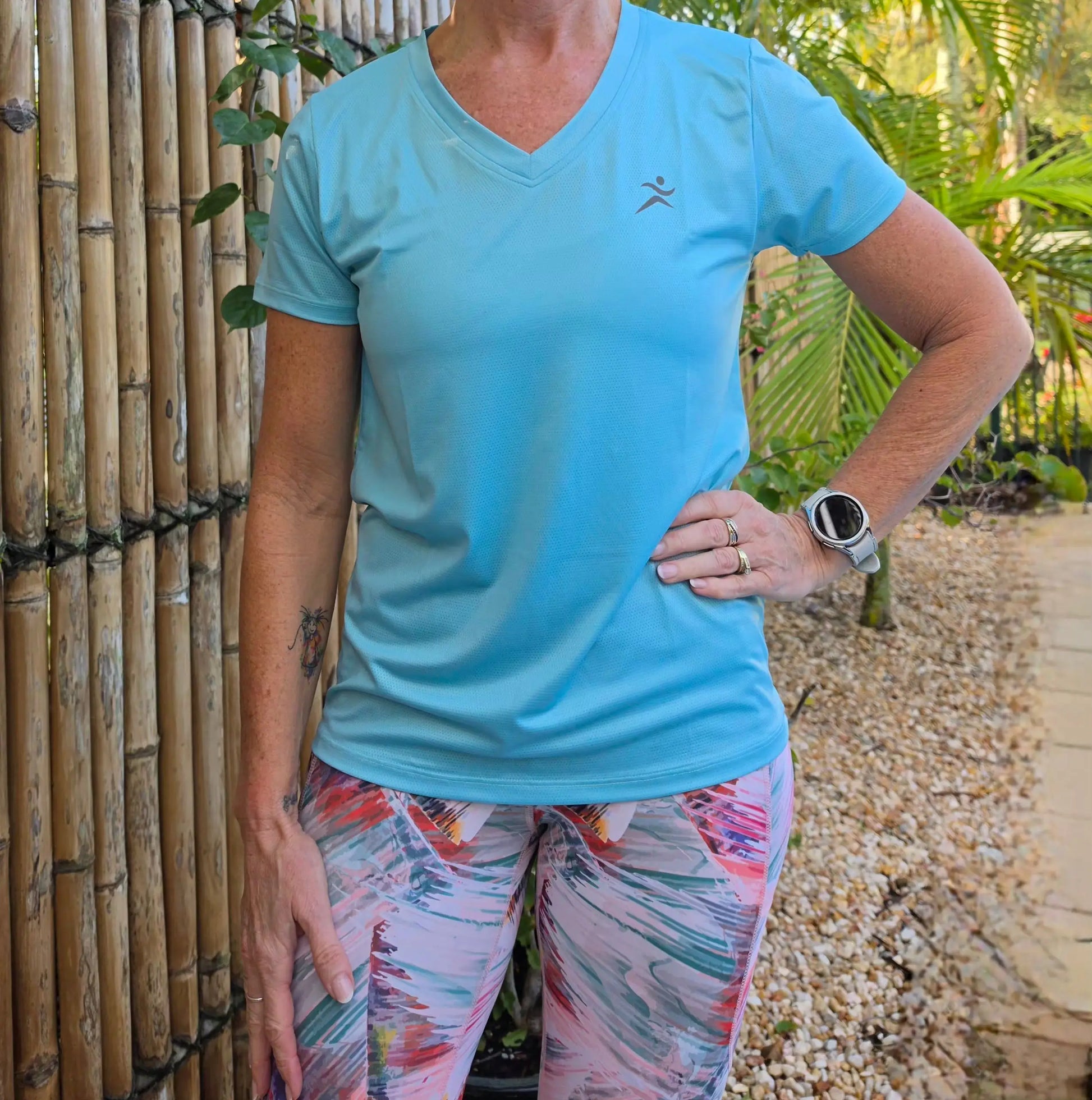 Light blue gmaxx mesh lightweight v-neck activewear top with dark gray running figure logo on left chest in sizes XS to 3XL