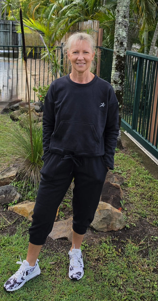 Black cropped sweatshirt with small white logo paired with kozy 3/4 fleecy pants with pockets for cool days winter wardrobe winner