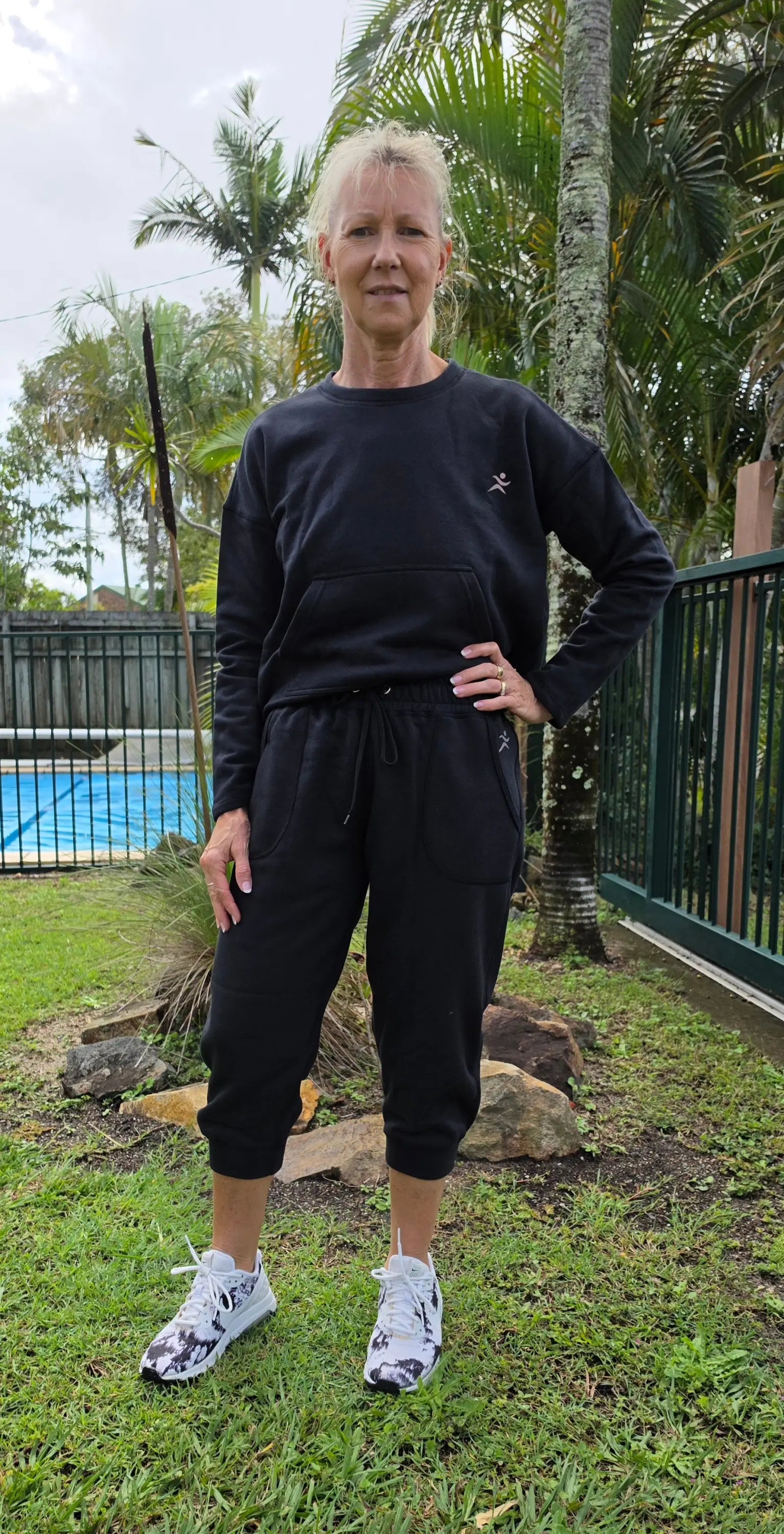 Black long-sleeved sweatshirt with small white star logo paired with fleecy pant pockets winter wardrobe winner for cool days