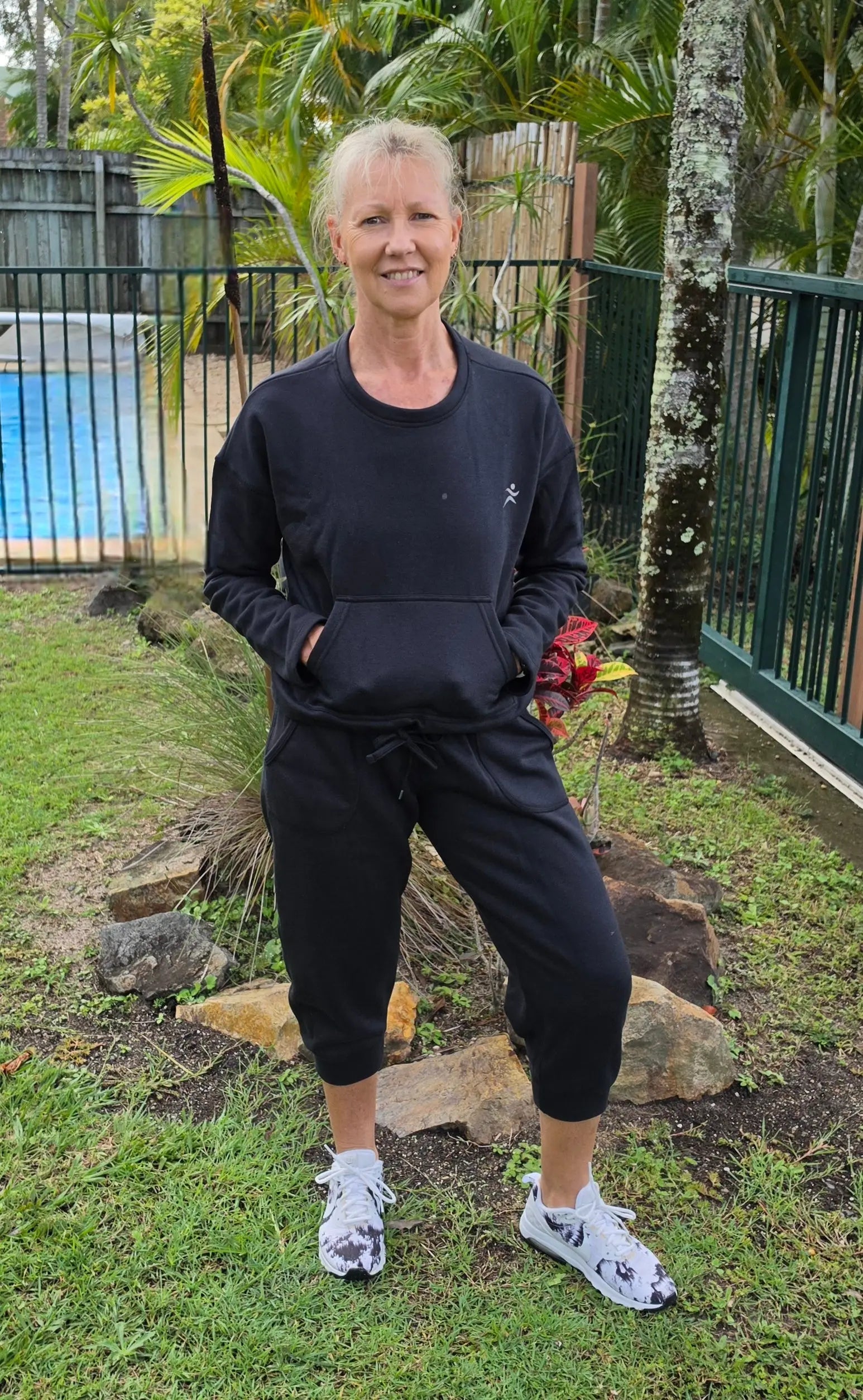 Black kozy fleecy athletic sweatshirt with small white logo made of cotton polyester ideal for activewear with pockets