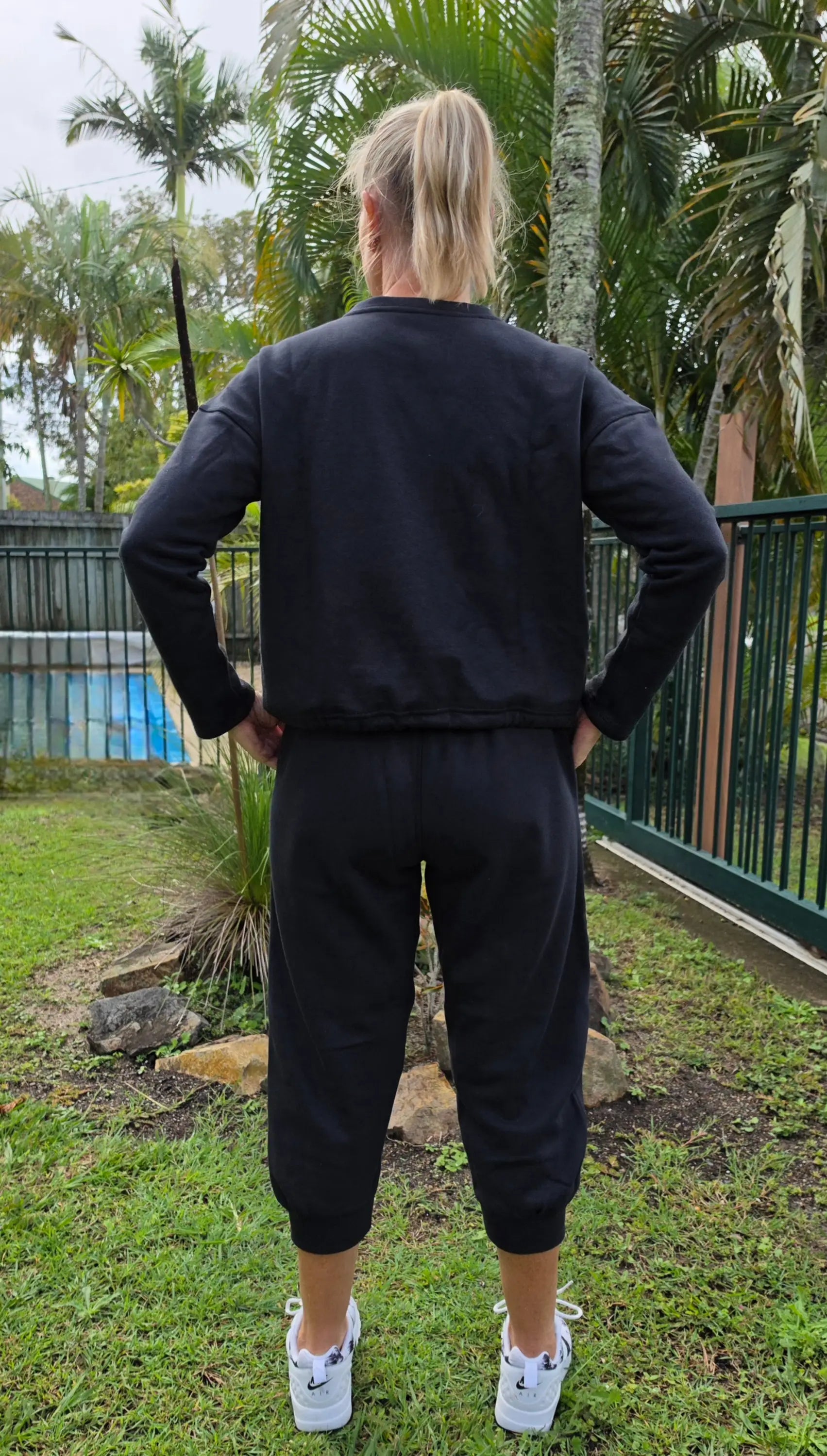 Black kozy fleecy top with pockets, cropped long sleeves, elastic cuffs, cotton polyester activewear jacket