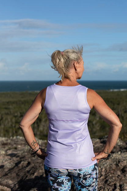 Lilac Full Back Sports Singlet    Super comfortable light weight Sports Singlets Specially designed for those that prefer a looser fit The generous length sits nicely over hips and bottom Moisture wicking properties will keep you cool and dry Fade resistant Polyester/Spandex Features a Full Back Design The hemline also features a slight scalloped finish.