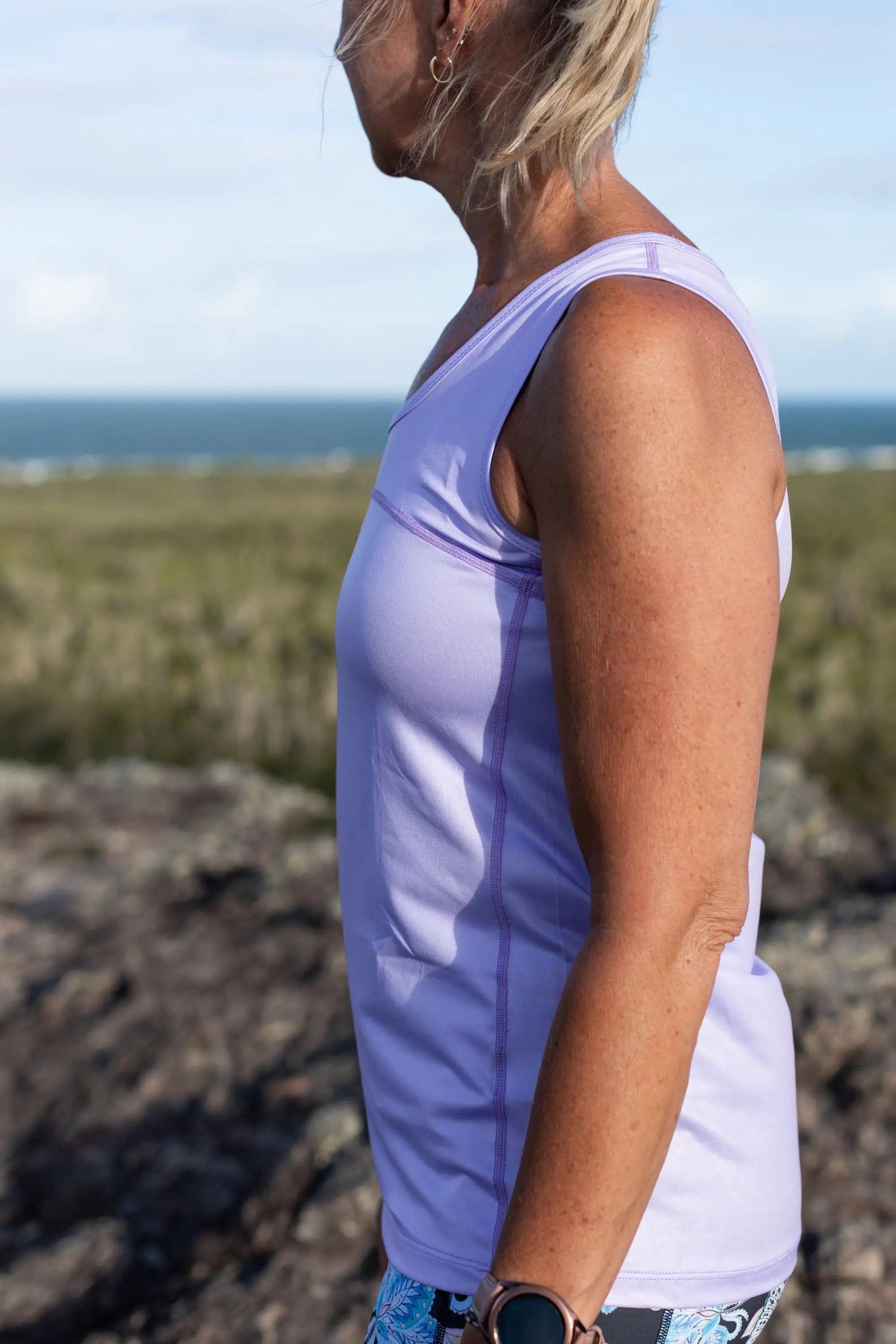 Lilac Full Back Sports Singlet    Super comfortable light weight Sports Singlets Specially designed for those that prefer a looser fit The generous length sits nicely over hips and bottom Moisture wicking properties will keep you cool and dry Fade resistant Polyester/Spandex Features a Full Back Design The hemline also features a slight scalloped finish.
