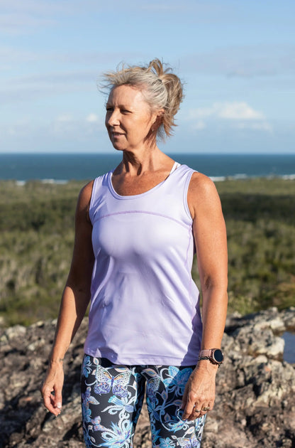 Lilac Full Back Sports Singlet    Super comfortable light weight Sports Singlets Specially designed for those that prefer a looser fit The generous length sits nicely over hips and bottom Moisture wicking properties will keep you cool and dry Fade resistant Polyester/Spandex Features a Full Back Design The hemline also features a slight scalloped finish.