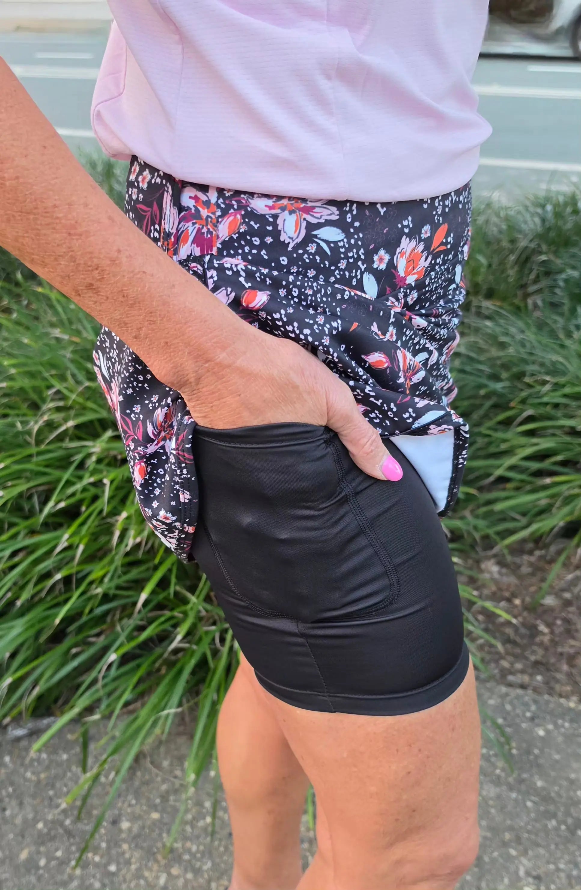 Black morgan longer skort with pockets featuring a floral patterned fabric and sleek fitted design