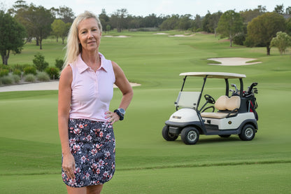 A woman wearing a sleeveless pink polo shirt paired with a morgan longer skort with pockets in a casual outfit