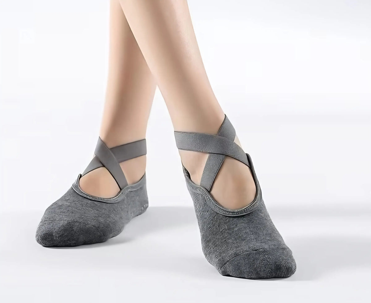 Gray crossover strap slip yoga socks with soft textured fabric and minimalist design for non slip yoga use