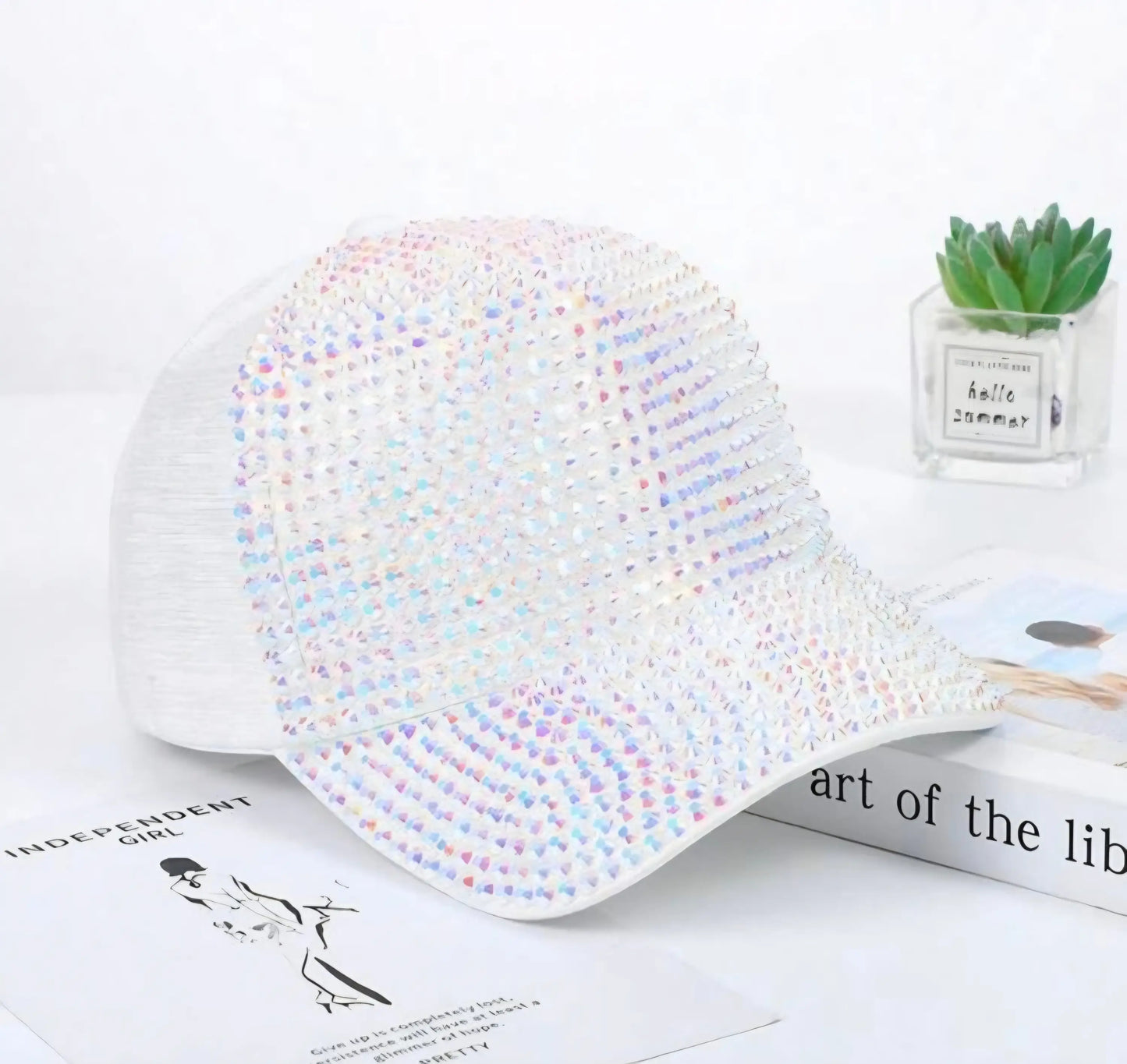 A white rhinestone peaks baseball cap covered with vibrant iridescent rhinestones for stylish wear