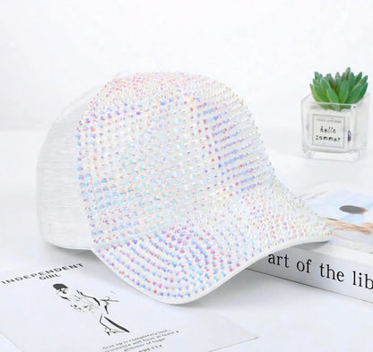 A white rhinestone peaks baseball cap covered with vibrant iridescent rhinestones for stylish wear