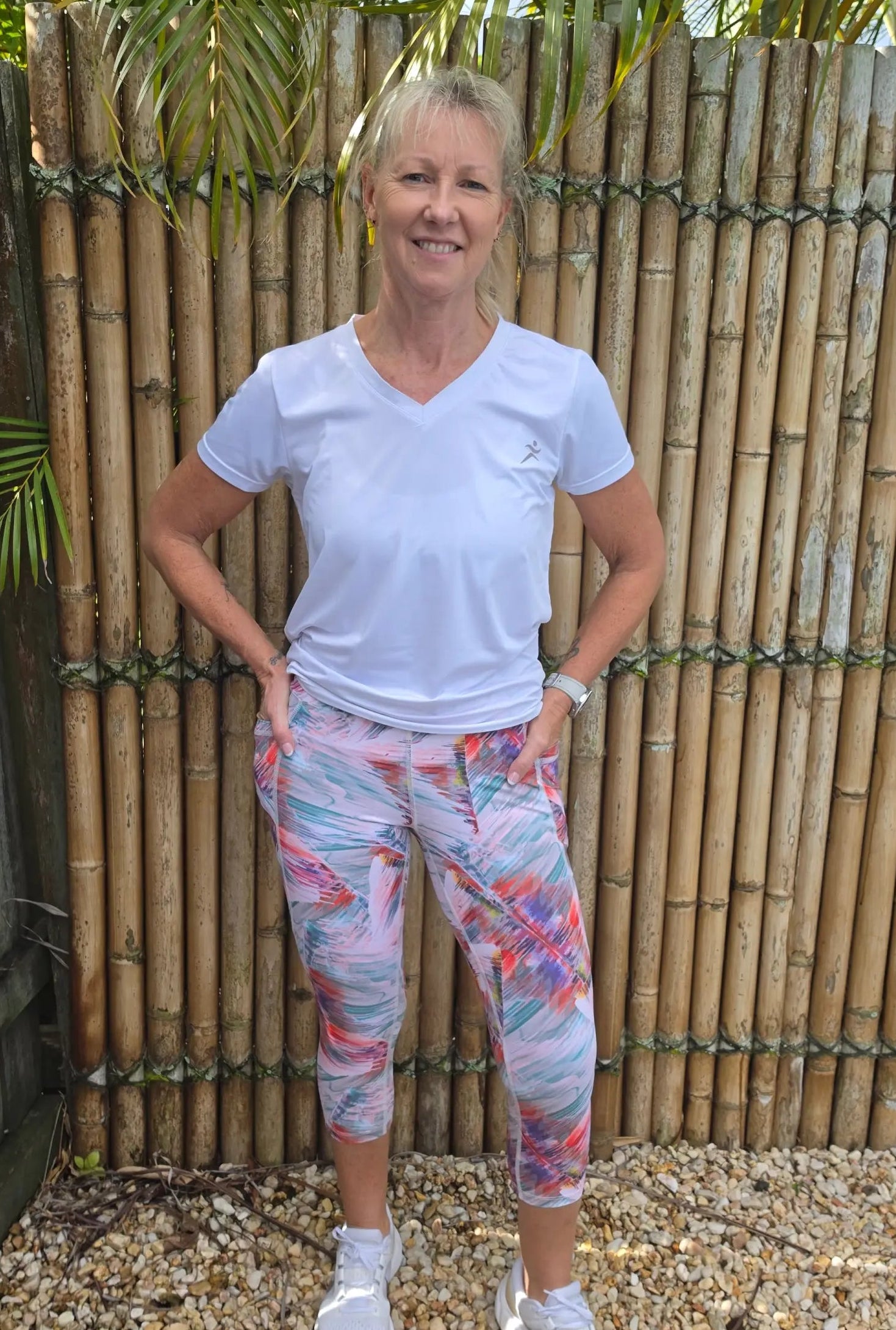 White v-neck moisture wicking athletic t-shirt with small logo on left chest paired with toni 3/4 active leggings activewear