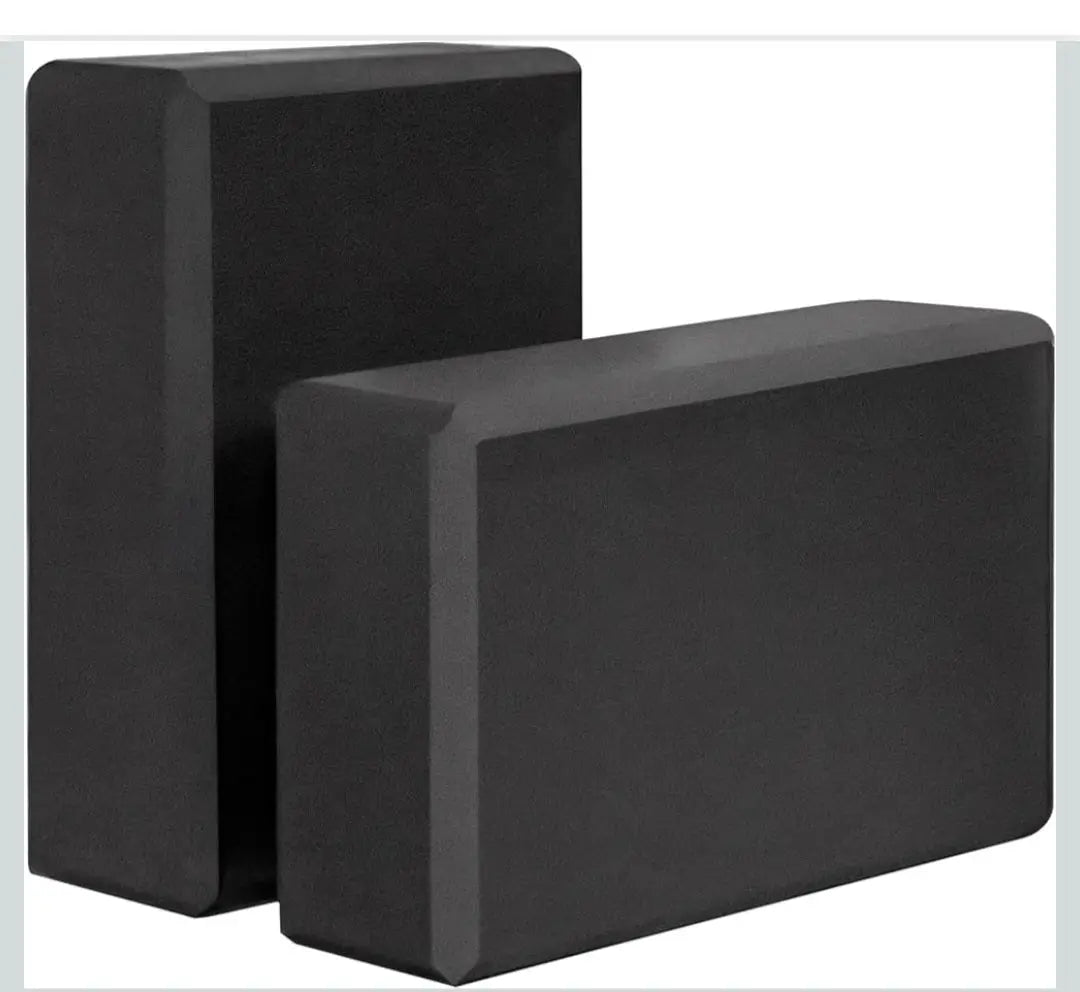 Black rectangular yoga blocks with a matte non slip surface made of foam blocks for stable support in activewear routines