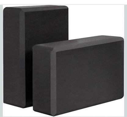 Black rectangular yoga blocks with a matte non slip surface made of foam blocks for stable support in activewear routines