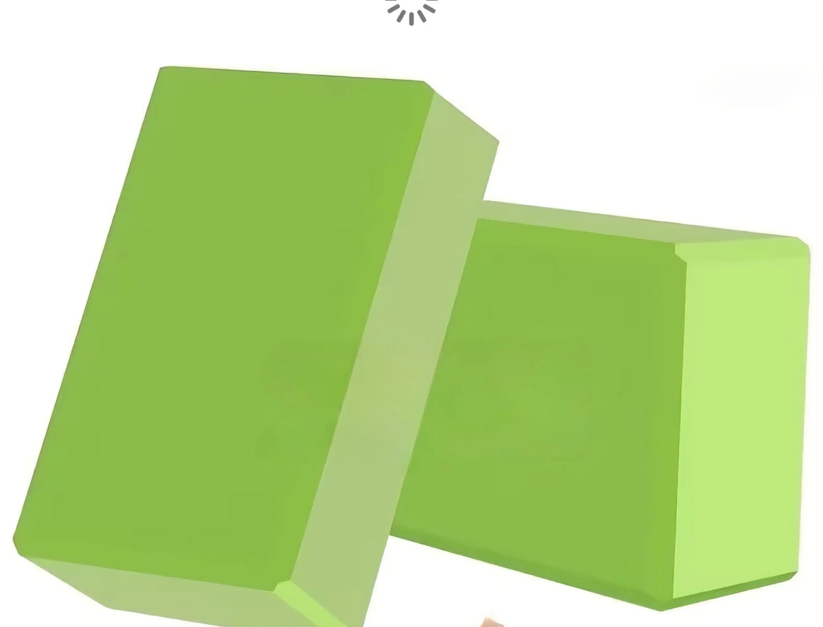 Two solid green foam yoga blocks with a smooth rectangular surface ideal for activewear exercise support