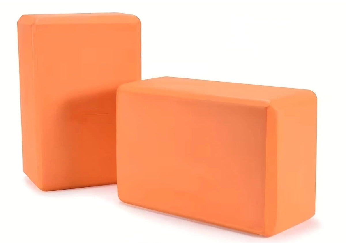 Orange yoga blocks made of smooth matte foam with rounded edges designed for activewear and fitness use