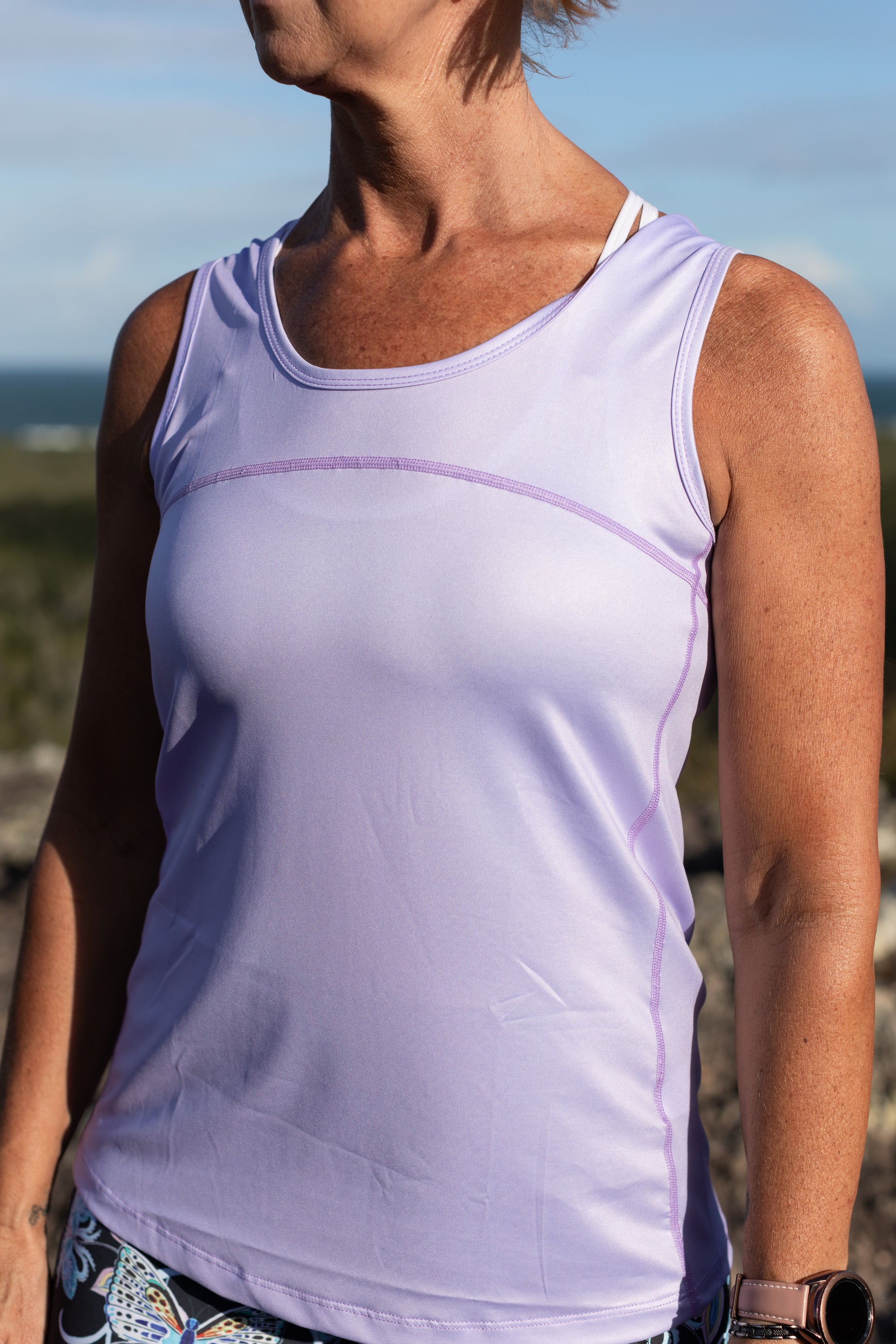 Lilac Full Back Sports Singlet    Super comfortable light weight Sports Singlets Specially designed for those that prefer a looser fit The generous length sits nicely over hips and bottom Moisture wicking properties will keep you cool and dry Fade resistant Polyester/Spandex Features a Full Back Design The hemline also features a slight scalloped finish.